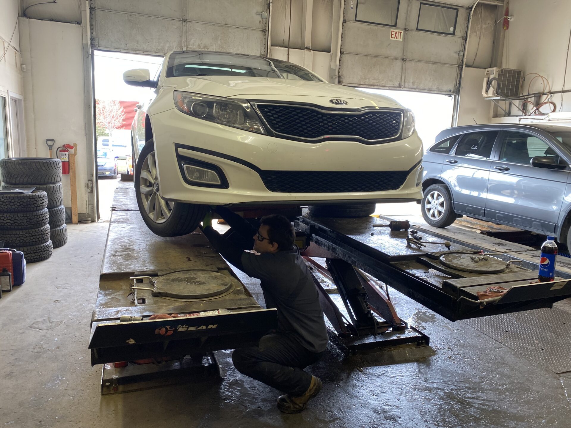 Car hoisted as the wheels are being changed.
